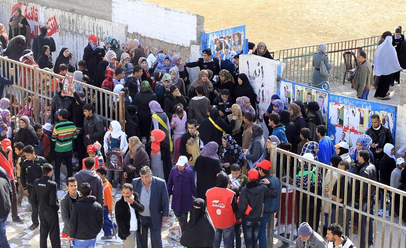 Jordanians queue outside a polling station in the Palestinian refugee camp of Baqaa, north of Amman, on January 23, 2013. Jordanians are voting in a parliamentary poll snubbed by Islamists who have staged strident pro-reform protests and who have already slammed what is expected to be an opposition-free body as illegitimate. AFP PHOTO/KHALIL MAZRAAWI
 *** Local Caption ***  325214-01-08.jpg