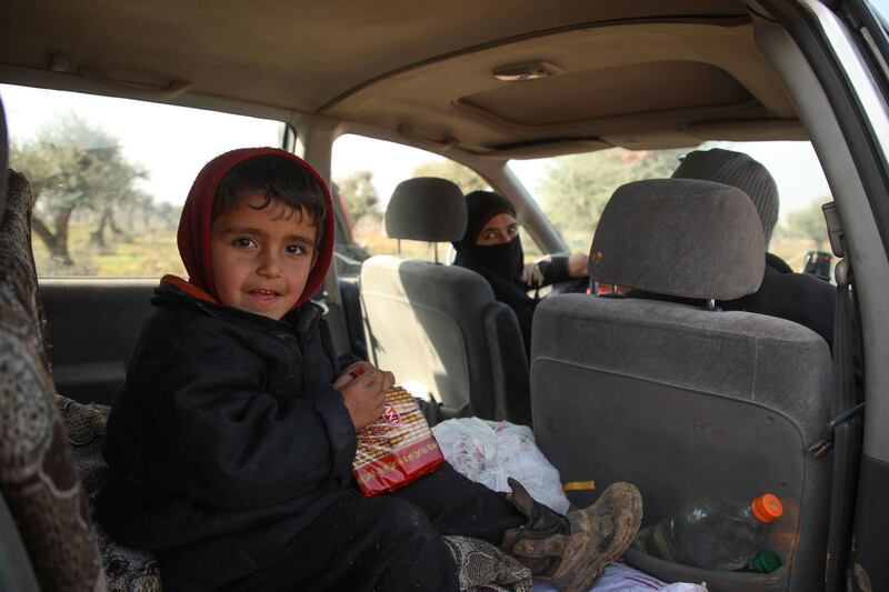 Displaced Ghossoon and her family rest in their parked car on the outskirts of Maaret Misrin town in Syria's Idlib province after fleeing regime and Russian bombardment.   AFP