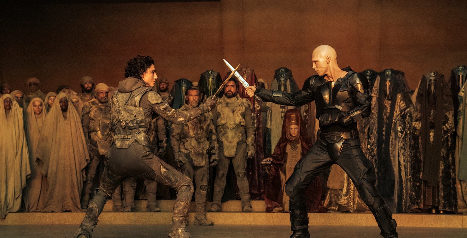 This image released by Warner Bros.  Pictures shows Timothee Chalamet, foreground left, and Austin Butler in a scene from "Dune: Part Two. " (Warner Bros.  Pictures via AP)