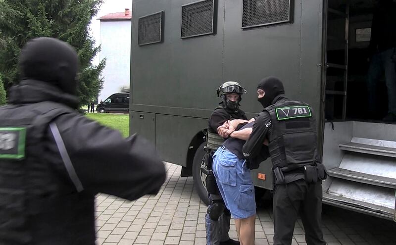 Belarus says the detained Russian men are facing a criminal probe on charges of plotting riots during the country's presidential election campaign. State TV and Radio via AP