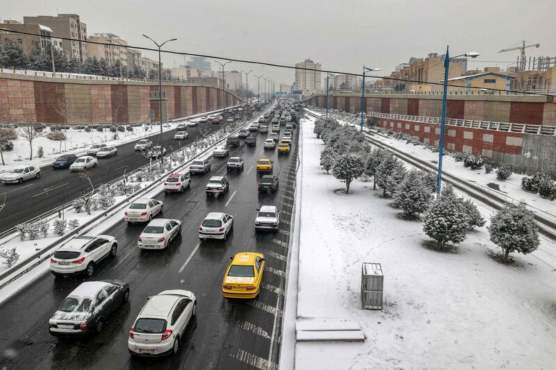 Traffic moves slowly through the snowy streets of Tehran. AFP