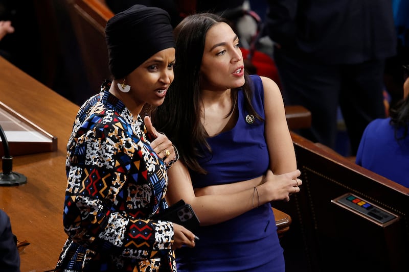 Democratis Ilhan Omar and Alexandria Ocasio-Cortez speak in the House chamber after the legislative body fails to elect a speaker. AFP
