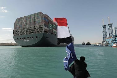 A man waves the Egyptian flag after the Panama-flagged ‘Ever Given’ container ship was dislodged from the banks of the Suez Canal. AFP