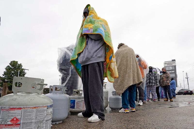 Carlos Mandez waits in line to fill his propane cylinders in Houston. Millions in Texas are without electricity after record snowfall and single-digit temperatures disrupted supply, causing widespread power cuts. AP Photo