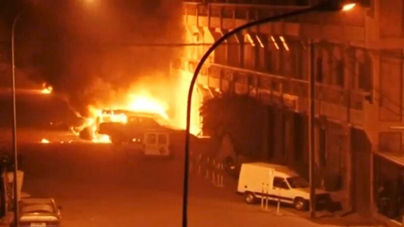 Vehicles on fire outside the Splendid Hotel in Ouagadougou, capital of Burkina Faso, after it was attacked by Al Qaeda militants on the night of January 15, 2016.  Reuters TV / Reuters