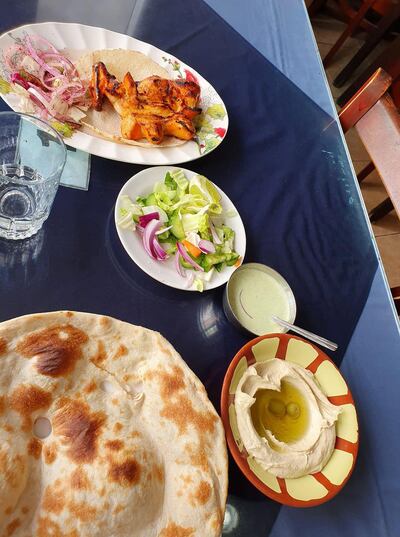 Vertical image of food including chicken tikka at Al Ibrahami Restaurant in Abu Dhabi. Rob McKenzie for The National


