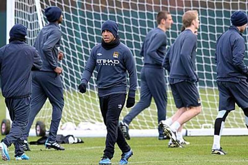 Carlos Tevez, centre, is expected to be stripped of the Manchester City captaincy for tonight’s match.