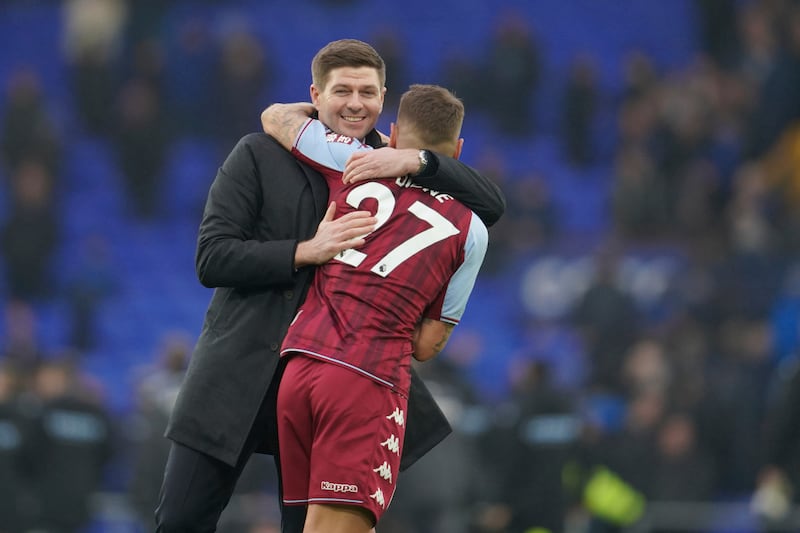 Aston Villa's head coach Steven Gerrard hugs Aston Villa's Lucas Digne after the English Premier League soccer match between Everton and Aston Villa at the Goodison Park stadium, in Liverpool, England, Saturday Jan.  22, 2022.  (AP Photo / Jon Super)