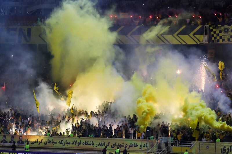 Fans of Sepahan light flares and smoke in the stands after their AFC Champions League match against Al Ittihad was cancelled. EPA