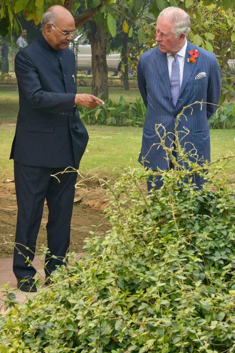 India's President Ram Nath Kovind chats with Prince Charles at the herbal garden in the presidential palace in New Delhi. AFP