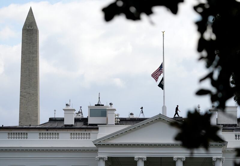 With the Washington Monument in the background, the American flag flies at half-mast over the White House. AP