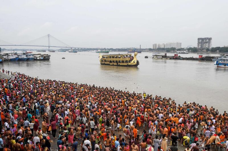 Hindu devotees perform "Tarpan" rituals to pay obedience to their forefathers on the last day of "Pitru Paksha", or days for offering prayers to ancestors, on the banks of the Ganges river in Kolkata.   AFP