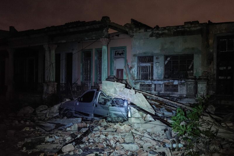 A damaged car flattened by debris from a building is seen in the tornado-hit Luyano neighbourhood in Havana early on January 28.
AFP