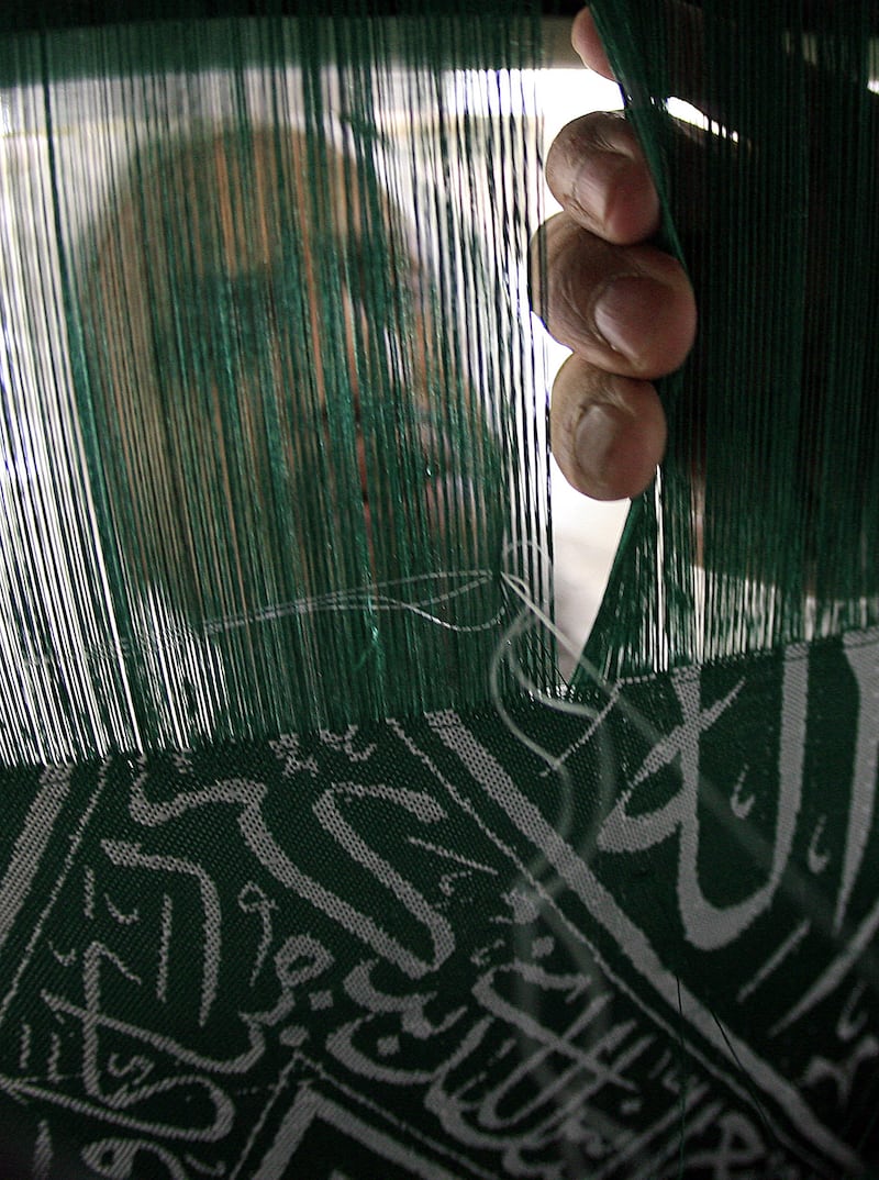 A Saudi man at the Kiswa factory in Makkah creates a drape bearing Islamic calligraphy to cover the Kaaba in 2008. The Kiswa is changed every year.