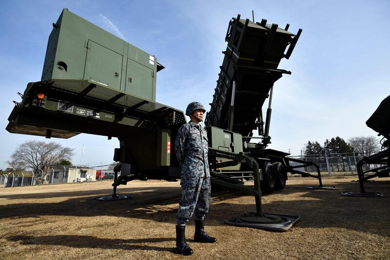 epaselect epa06448455 A Japan Ground Self-Defense Force (JGSDF) soldier stands at guard before a Patriot Advanced Capability-3 (PAC-3) ballistic missiles interceptor deployed at Camp Narashino in Funabashi, Chiba Prefecture, Japan, 18 January 2018.  EPA/FRANCK ROBICHON