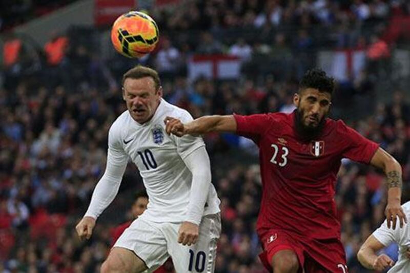 Wayne Rooney, left, had to be replaced in the 66th minute against Peru. Adrian Dennis / AFP