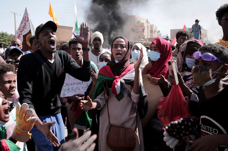 People chant slogans in Khartoum. AP