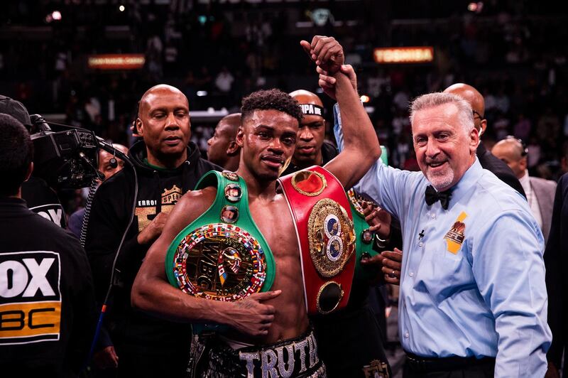 epa07878670 Errol Spence Jr. (C) of the USA celebrates after winning against Shawn Porter of the USA during their WBC and IBF World Welterweight Championship fight at Staples Center in Los Angeles, California, USA, 28 September 2019.  EPA/FRANCK BACHINI