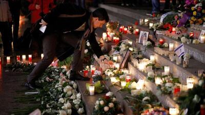 A mourner leaves a tribute at a memorial to the victims of the Berlin terrorist attack. EPA