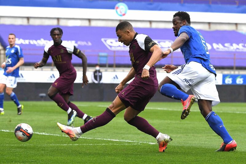 Paris Saint-Germain’s French forward Kylian Mbappe shoots and scores a goal during the French L1 football match between Strasbourg (RCSA) and Paris Saint-Germain (PSG) on April 10, 2021, at the Meinau Stadium in Strasbourg , eastern France. / AFP / PATRICK HERTZOG
