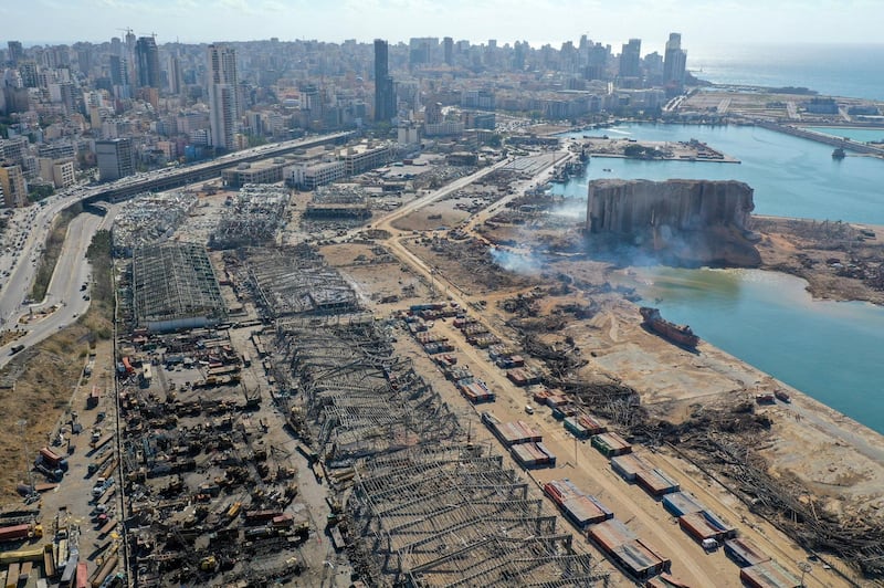 An aerial view shows the massive damage done to Beirut port's grain silos (C) and the area around it on August 5, 2020, one day after a mega-blast tore through the harbour in the heart of the Lebanese capital with the force of an earthquake, killing more than 100 people and injuring over 4,000. - Rescuers searched for survivors in Beirut in the morning after a cataclysmic explosion at the port sowed devastation across entire neighbourhoods, killing more than 100 people, wounding thousands and plunging Lebanon deeper into crisis. (Photo by - / AFP)