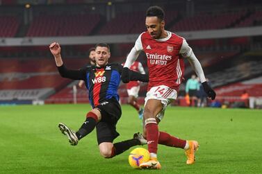 Crystal Palace's English defender Joel Ward (L) vie with Arsenal's Gabonese striker Pierre-Emerick Aubameyang (R) during the English Premier League football match between Arsenal and Crystal Palace at the Emirates Stadium in London on January 14, 2021. - RESTRICTED TO EDITORIAL USE. No use with unauthorized audio, video, data, fixture lists, club/league logos or 'live' services. Online in-match use limited to 120 images. An additional 40 images may be used in extra time. No video emulation. Social media in-match use limited to 120 images. An additional 40 images may be used in extra time. No use in betting publications, games or single club/league/player publications. / AFP / POOL / NEIL HALL / RESTRICTED TO EDITORIAL USE. No use with unauthorized audio, video, data, fixture lists, club/league logos or 'live' services. Online in-match use limited to 120 images. An additional 40 images may be used in extra time. No video emulation. Social media in-match use limited to 120 images. An additional 40 images may be used in extra time. No use in betting publications, games or single club/league/player publications.
