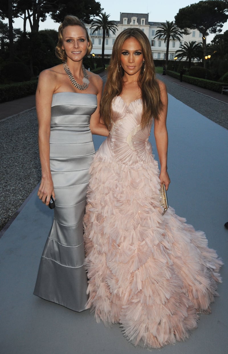 Charlene Wittstock, in a grey strapless gown, and Jennifer Lopez arrive at amfAR's Cinema Against AIDS 2010 benefit gala on May 20, 2010 in Antibes, France. Getty Images