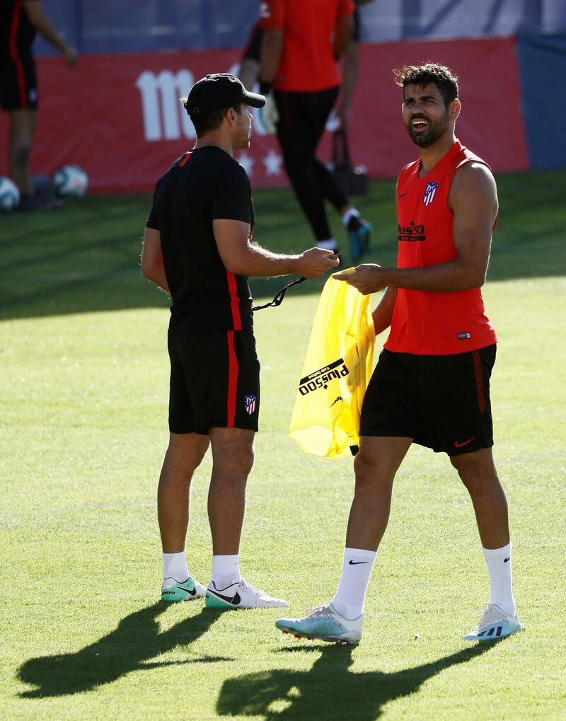 Costa is given a bib by manager Simeone.