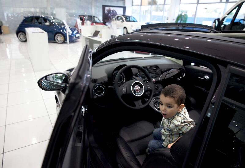 Abu Dhabi, United Arab Emirates, May 27, 2013: 
Young boys play in one of the Fiat display models while their parents shop around for a car on Monday, May 27, 2013, at the Emirates Motor Company showroom on Airport Road in Abu Dhabi.
Silvia Razgova / The National

