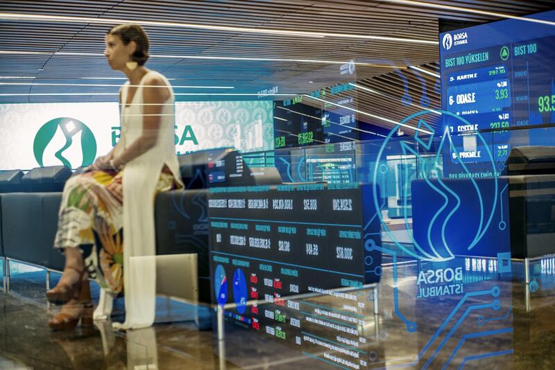 A member of the equities department sits beside digital screens displaying stock price information at the Borsa Istanbul SA stock exchange in Istanbul, Turkey, on Tuesday, Aug. 14, 2018. While they are growing more critical, the underlying tone of warnings from businesses has so far been supportive of the government in principle, showing there are limits to how much Turkey’s billionaires are feeling emboldened to speak out after elections in June increased President Recep Tayyip Erdogan’s grip on power. Photographer: Ismail Ferdous/Bloomberg