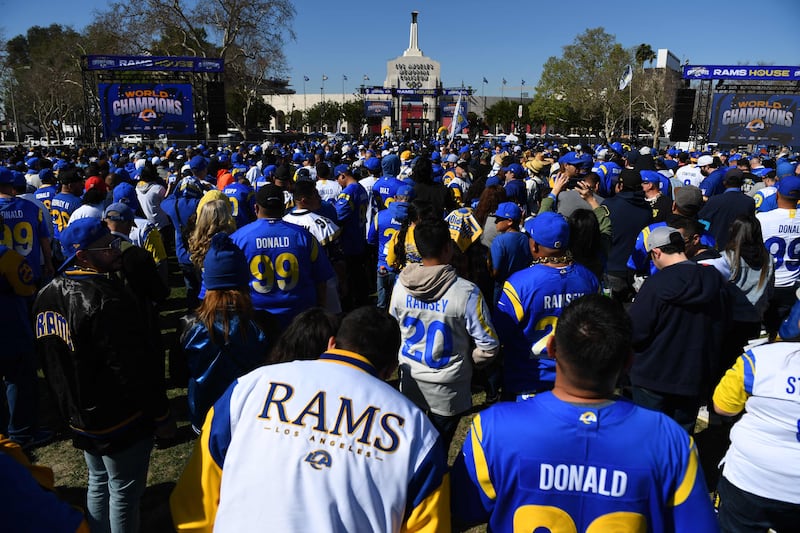 Fans celebrate outside of Los Angeles Memorial Coliseum during the Rams' victory parade. AFP