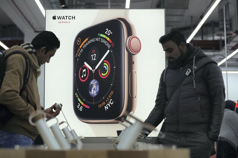 An illuminated Apple Watch Series 4 smartwatch advertisement stands as customers browse inside a Media Markt electronic goods store, operated by Ceconomy AG, in Berlin, Germany, on Monday, Dec. 17, 2018. Ceconomy announce full year earnings figures on Dec. 19. Photographer: Krisztian Bocsi/Bloomberg