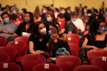 Spectators take a selfie while waiting for the start of a concert by Portuguese artists Bruno Nogueira and Manuela Azevedo at the Campo Pequeno bullring in Lisbon, Monday, June 1, 2020. Portugal is allowing concert halls to reopen from Monday as the government eases the coronavirus lockdown rules. (AP Photo/Armando Franca)