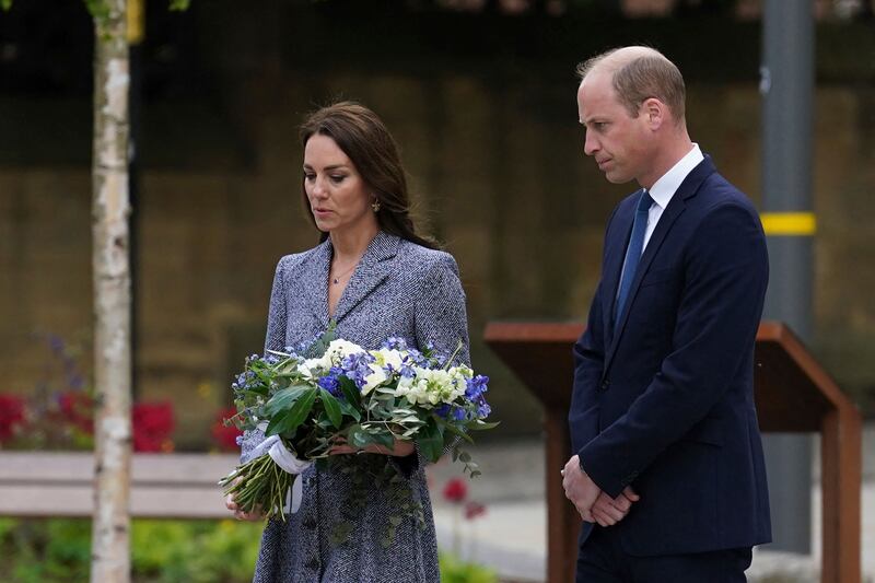 Prince William and Kate lay flowers at the Glade of Light memorial. AFP