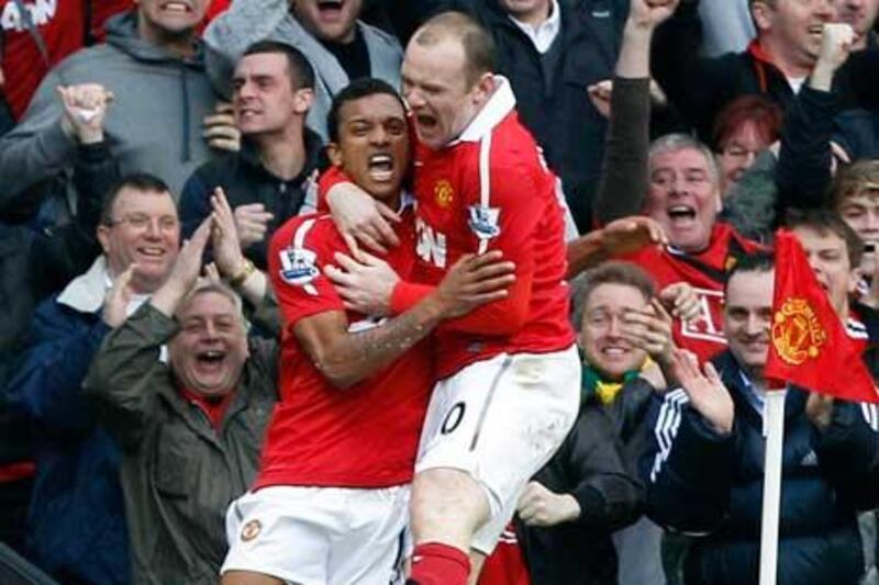 Manchester United's Wayne Rooney congratulates team mate Nani after he scored against Manchester City .