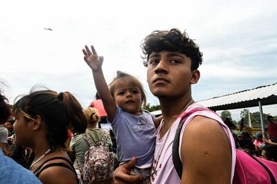 TOPSHOT - Honduran migrants taking part in a caravan heading to the US, arrive at the border crossing point with Mexico, in Ciudad Tecun Uman, Guatemala, on October 19, 2018. Honduran migrants who have made their way through Central America were gathering at Guatemala's northern border with Mexico on Friday, despite President Donald Trump's threat to deploy the military to stop them entering the United States. / AFP / ORLANDO SIERRA
