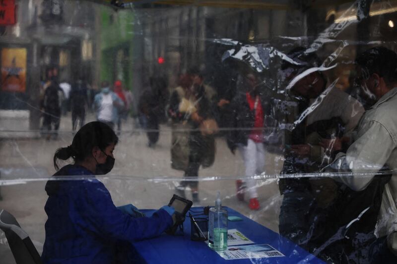 A healthcare administrator checks paperwork at a mobile Covid-19 testing centre outside Pennsylvania Station in New York City. Reuters