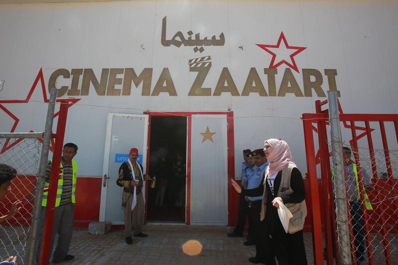 People and security forces gather at the entrance of the Cinema Zaatari in the Jordanian Zaatari camp for Syrian refugees. AFP
