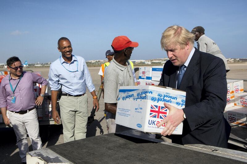 A handout photo released by UNICEF Somalia shows British Foreign Minister Boris Johnson (C) helping to load supplies to treat malnourished children affected by the severe drought in Somalia onto a cargo plane at Mogadishu International Airport on March 15, 2017. - Britain's Department for International Development (DFID) has provided £49 million (nearly $60 million) in emergency humanitarian funding to UNICEF and WFP, as part of as part of their additional £110 million (over $130 million) allocation to the 2017 Drought response. (Photo by KAREL PRINSLOO / UNICEF SOMALIA / AFP) / RESTRICTED TO EDITORIAL USE - MANDATORY CREDIT "AFP PHOTO / UNICEF SOMALIA / KAREL PRINSLOO" - NO MARKETING NO ADVERTISING CAMPAIGNS - DISTRIBUTED AS A SERVICE TO CLIENTS