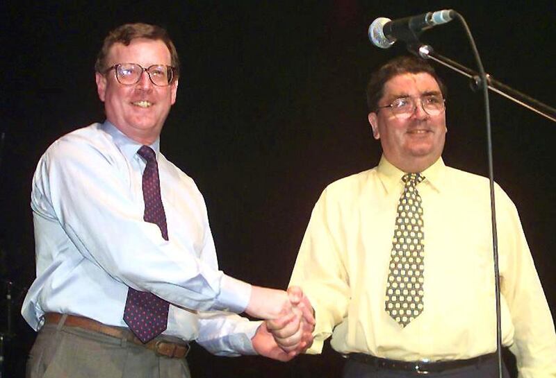 In this file photo taken on May 19, 1998 showing Ulster Unionist leader David Trimble, left, and John Hume shaking hands on stage during a concert given by U2 in Belfast to campaign for a Yes vote for the Good Friday Agreement peace referendum in Northern Ireland. AFP