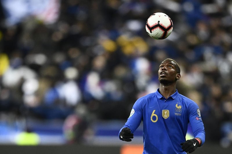 (FILES) This file photo taken on March 25, 2019 shows France's midfielder Paul Pogba heading the ball during the UEFA Euro 2020 Group H qualification football match between France and Iceland at the Stade de France stadium in Saint-Denis, north of Paris.	 Manchester United's Paul Pogba said on October 26, 2020 that reports claiming he had retired from international duty in protest against French President Emmanuel Macron's comments about radical Islam were "fake news". / AFP / Martin BUREAU
