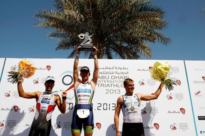 Abu Dhabi, United Arab Emirates, March 2, 2013:    Fredrick Van Lierde of Belgium, centre, celebrates racing to victory with second place finisher Eneko Llanos of Spain, left, and third place finisher Tyler Butterfield of Australia during the male long distance of the Abu Dhabi International Triathlon in Abu Dhabi on March 2, 2013. Christopher Pike / The National