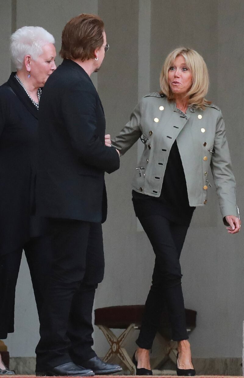 Brigitte, wearing a slate jacket with gold button detail, and Irish U2 star Bono at the Elysee Palace on July 24, 2017. AFP