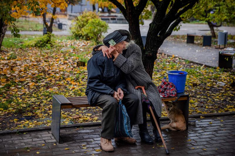 An elderly couple hug each other in the frontline town of Bakhmut, in eastern Ukraine's Donetsk region. The town, has been under attack for months by Russian forces. AFP
