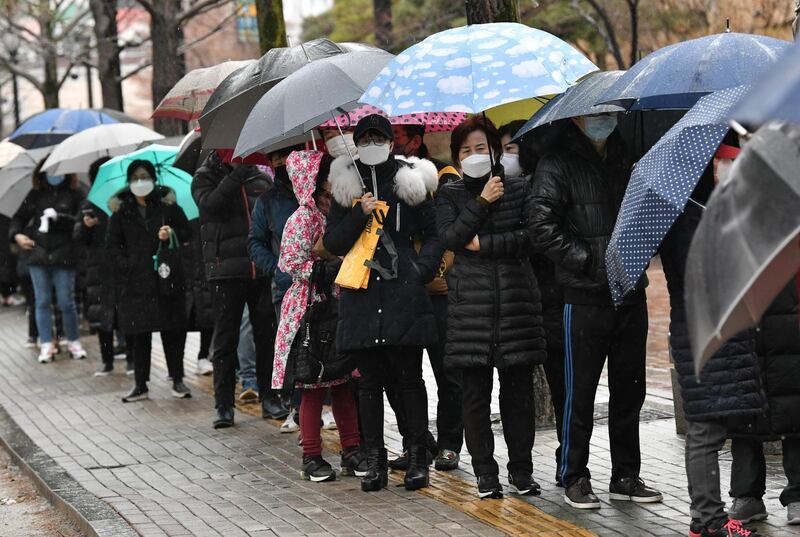 People wait in a line to buy face masks at a retail store in the southeastern city of Daegu, South Korea. AFP