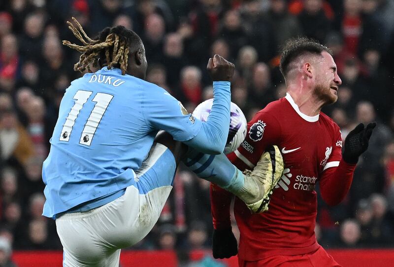 Manchester City's Jeremy Doku kicks Liverpool's Alexis Mac Allister but VAR ruled it was not a penalty. AFP