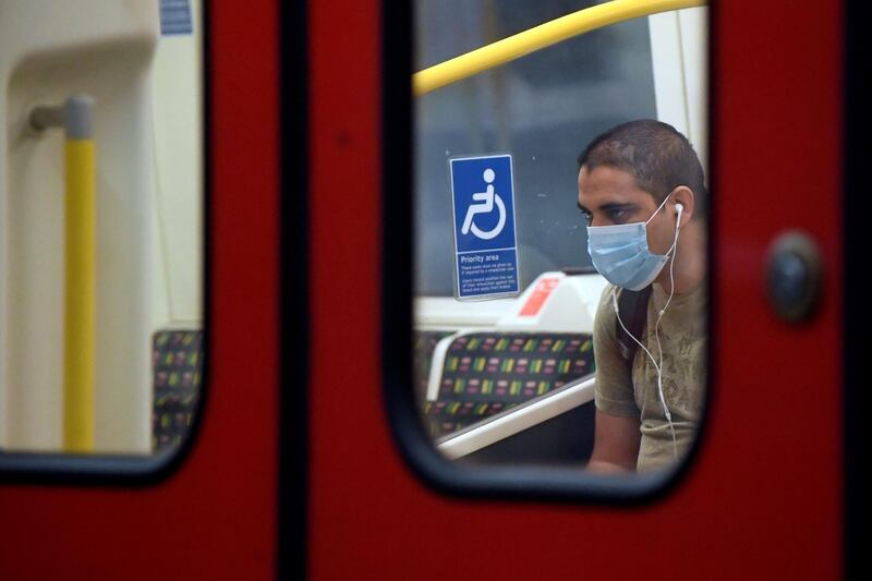 A man wears a protective face mask whilst travelling on the London Underground. Reuters