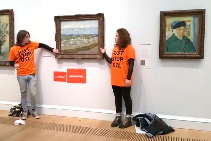 Two activists glued themselves to the frame of Vincent van Gogh’s 'Peach Trees in Blossom' (1889) at The Courtauld Gallery in London on June 30. Photo: Just Stop Oil