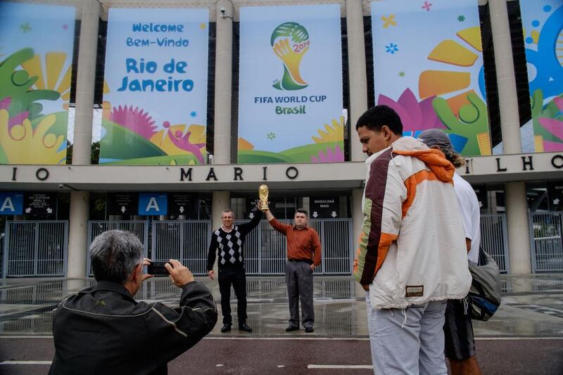 A tourist takes pictures in front of the Maracana stadium in Rio de Janeiro, decorated for the upcoming Fifa World Cup. Yasuyoshi Chiba / AFP