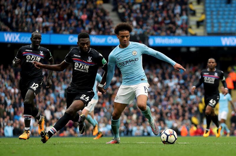 Crystal Palace defender Timothy Fosu-Mensah, left, and Manchester City's Leroy Sane battle for the ball. Nick Potts / PA